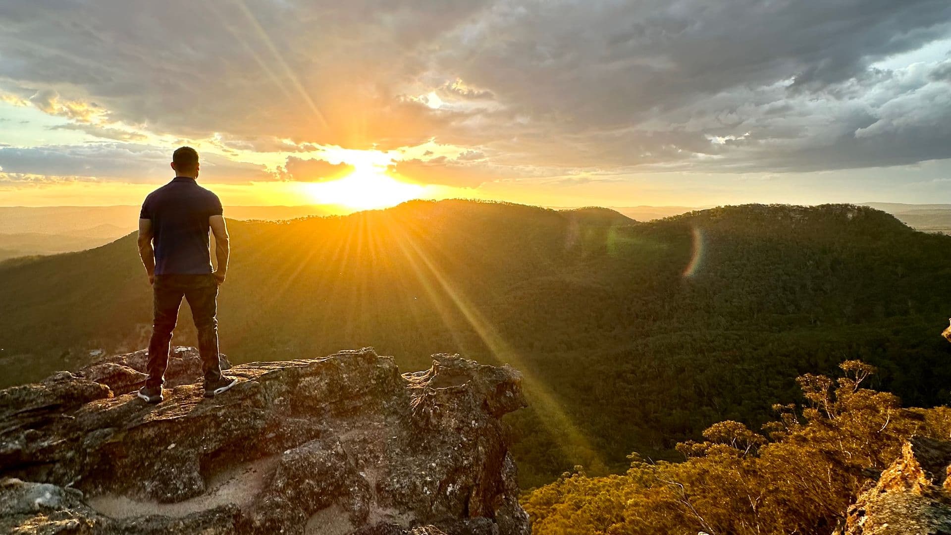 Sunset over Megalong Valley from Sunset Rock, Blue Mountains — vivid orange and pink sky above a vast forested valley