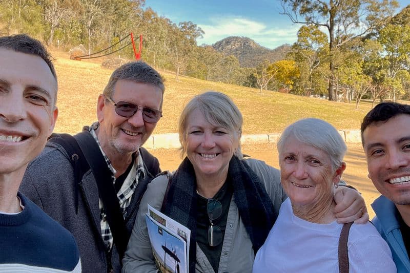 Group of five people including tour guide at a boutique vineyard in the Broke-Fordwich wine region, Hunter Valley, NSW.