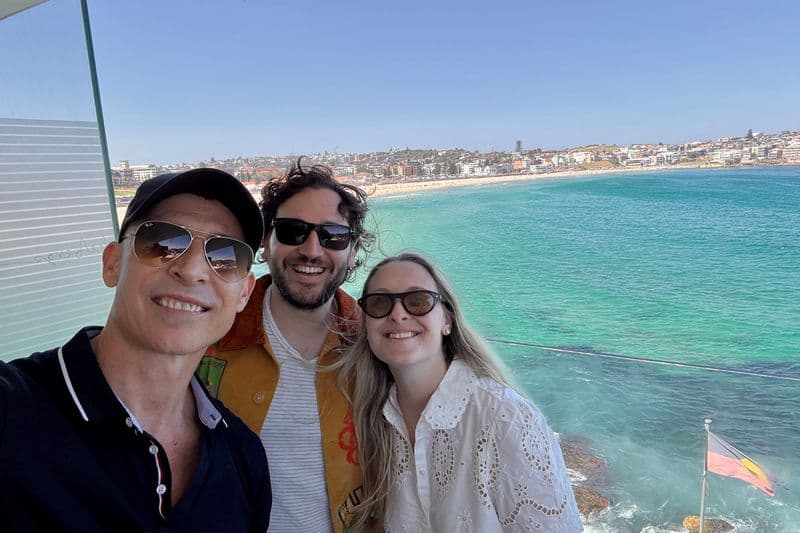 Smiling American couple at Bondi Beach near Icebergs Ocean Pool on a sunny Sydney day