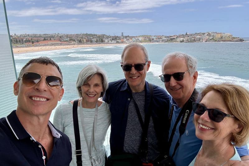 Group of American tourists posing at a secret lookout near Icebergs pool, Bondi Beach, Sydney, on a private guided tour.
