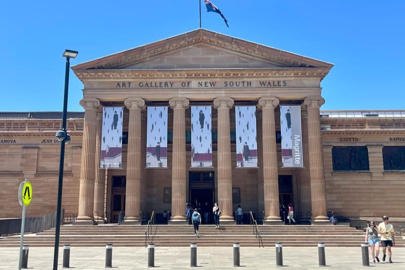 Classical Greek temple-style entrance colonnade of the Art Gallery of New South Wales, Sydney, featuring grand stone columns.