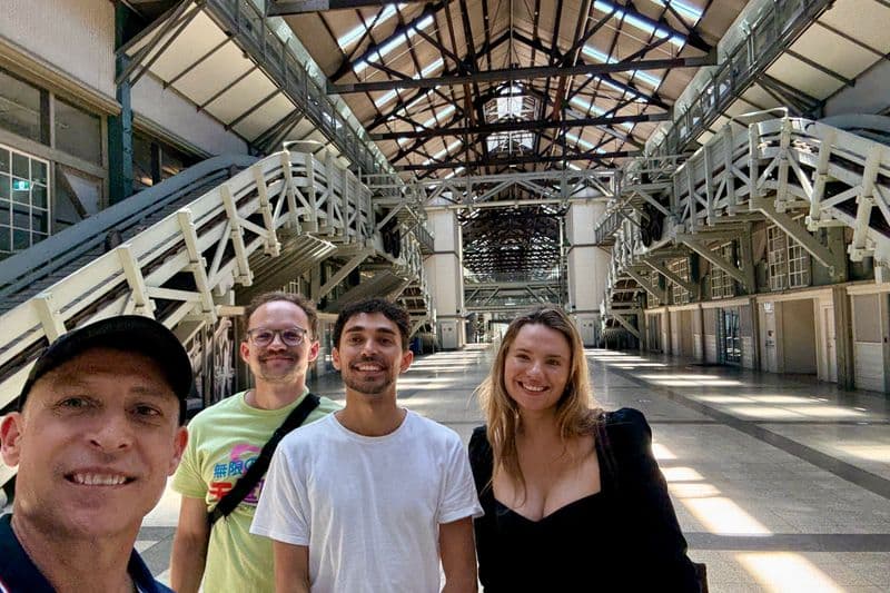 Four people inside the heritage-listed Woolloomooloo Finger Wharf on a private Sydney architecture walking tour.