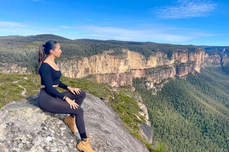 Woman overlooking Grose Valley's dramatic sandstone cliffs in the Blue Mountains, New South Wales, Australia