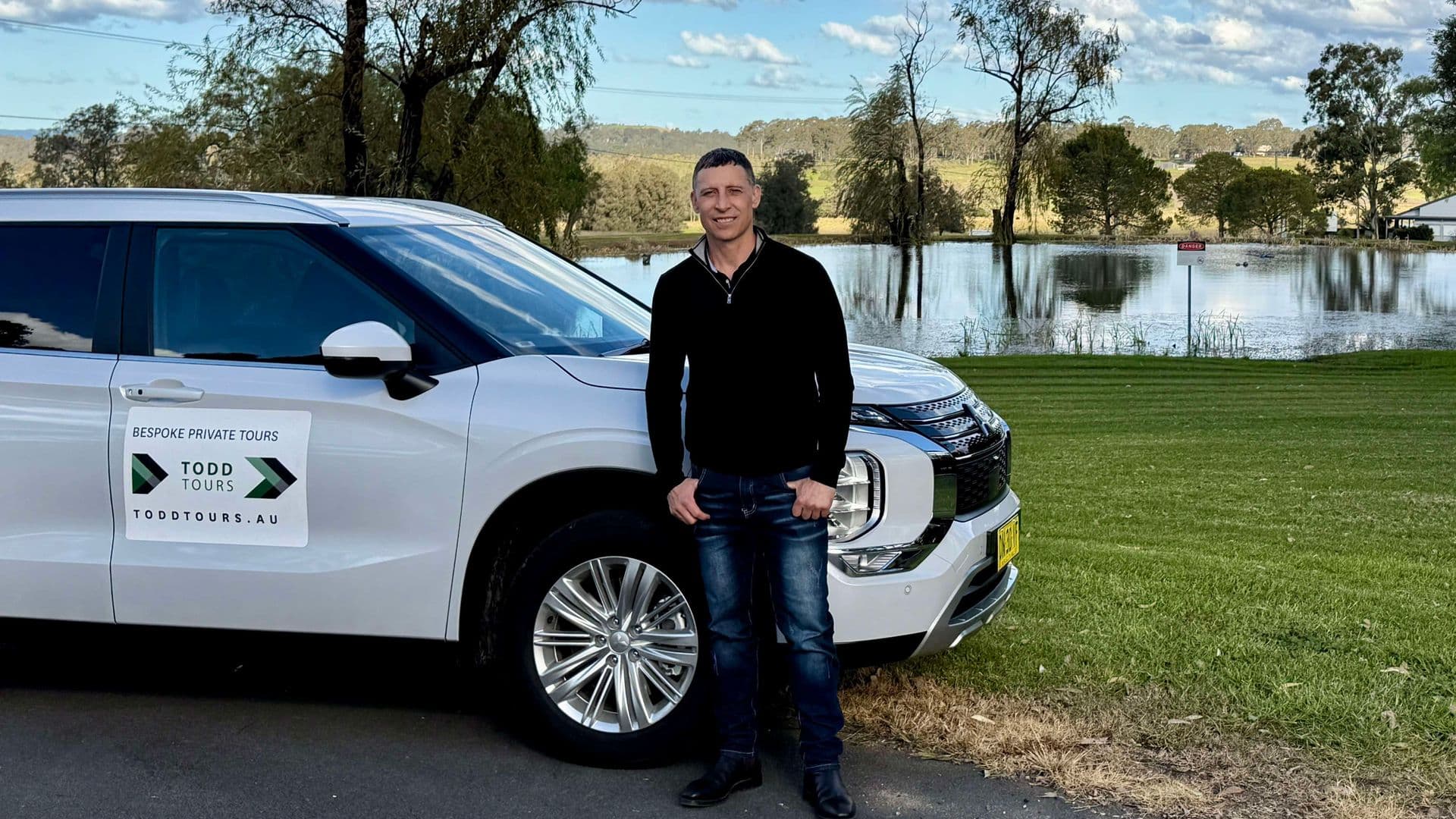 Todd Craft, private tour guide, standing in front of a brand new SUV in Hunter Valley wine country near Beaume Restaurant.