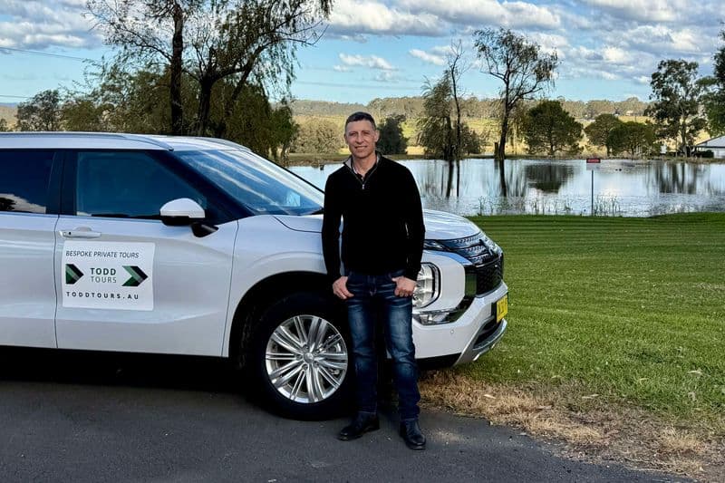 Todd Craft, private tour guide, standing in front of a brand new SUV in Hunter Valley wine country near Beaume Restaurant.